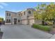 Spacious two-story stucco home featuring a three-car garage, landscaped yard, and concrete driveway at 9582 W Albert Ln, Peoria, AZ 85382