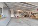Spacious garage with ample storage cabinets and overhead shelving provides great organizational opportunities at 9582 W Albert Ln, Peoria, AZ 85382
