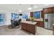 Modern kitchen features dark wood cabinets, stainless steel appliances, and a central island at 9582 W Albert Ln, Peoria, AZ 85382