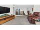 Cozy upstairs living area with a TV, leather chair, and staircase view at 9582 W Albert Ln, Peoria, AZ 85382