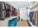 Organized walk-in closet with shelves, hanging rods, and two blue laundry bins at 9582 W Albert Ln, Peoria, AZ 85382