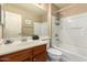 Bathroom featuring vanity with sink, a shower and tub combination, a toilet, and a mirror at 10062 E Isleta Ave, Mesa, AZ 85209