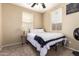 Comfortable bedroom with neutral walls, carpet flooring, natural light, and simple furnishings at 10062 E Isleta Ave, Mesa, AZ 85209