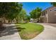 Green community park featuring mature trees, sidewalk, playground, and lawn at 10062 E Isleta Ave, Mesa, AZ 85209