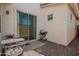 Cozy outdoor patio area with seating and a barbecue grill, surrounded by gravel and a stucco wall at 10062 E Isleta Ave, Mesa, AZ 85209