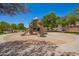 Community playground with slide, shaded by mature trees at 10062 E Isleta Ave, Mesa, AZ 85209