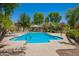 Community swimming pool with lounge chairs, shady gazebo, and mature trees at 10062 E Isleta Ave, Mesa, AZ 85209