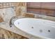 Close-up of an elegant bathtub with tile accents and stylish fixtures at 1032 E Dolores Rd, Phoenix, AZ 85086