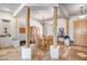 Bright dining area featuring an elegant chandelier, rustic wooden columns, and travertine tile floors at 1032 E Dolores Rd, Phoenix, AZ 85086