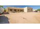Front exterior with ample parking on a desert lot featuring native landscaping and curb appeal, providing a welcoming entrance at 1032 E Dolores Rd, Phoenix, AZ 85086