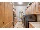 Well-equipped laundry room with washer, dryer, ample cabinet space, and tiled flooring at 1032 E Dolores Rd, Phoenix, AZ 85086