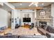Spacious living room with stone fireplace, wood beams, large TV, and comfortable leather seating at 1032 E Dolores Rd, Phoenix, AZ 85086