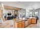 Spacious open floorplan featuring kitchen island with stone countertop and views of the living room and fireplace at 1032 E Dolores Rd, Phoenix, AZ 85086