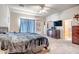 Spacious main bedroom featuring a ceiling fan, TV, and private ensuite bathroom access at 1032 E Dolores Rd, Phoenix, AZ 85086