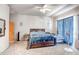 Large bedroom featuring carpet, a window with blinds, and a comfortable queen sized bed at 1032 E Dolores Rd, Phoenix, AZ 85086