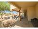 Large covered outdoor patio with desert landscape, grill, and furniture at 1032 E Dolores Rd, Phoenix, AZ 85086