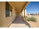 Covered porch providing a shaded outdoor space and walkway along side of home at 1032 E Dolores Rd, Phoenix, AZ 85086