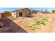 The backyard features a covered patio and a rock perimeter at 10429 W Miami St, Tolleson, AZ 85353