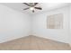 A clean bedroom with tile floors, a window, and a ceiling fan at 10429 W Miami St, Tolleson, AZ 85353