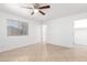 Inviting bedroom with tiled flooring, neutral walls, and a window with blinds at 10429 W Miami St, Tolleson, AZ 85353