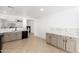 Bright kitchen with marble countertops, stainless steel sink, tile flooring, and ample storage at 10429 W Miami St, Tolleson, AZ 85353
