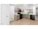 Cozy kitchen featuring white cabinets, updated appliances, tile flooring, and modern countertops at 10429 W Miami St, Tolleson, AZ 85353