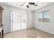 Bright living room with tiled floors, ceiling fan, and sliding glass doors to the backyard at 10429 W Miami St, Tolleson, AZ 85353