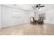 Open-concept room featuring tile flooring, a ceiling fan, and windows with coverings at 10429 W Miami St, Tolleson, AZ 85353