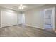 Bedroom with wood-look floors, walk-in closet, and access to the bathroom at 11133 W Cameo Dr, Sun City, AZ 85351