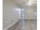 Bright bedroom with wood-look floors and a ceiling fan at 11133 W Cameo Dr, Sun City, AZ 85351