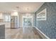 Inviting dining area featuring stylish chandelier, stainless steel fridge, and sliding glass doors at 11133 W Cameo Dr, Sun City, AZ 85351