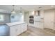 Bright kitchen featuring stainless steel appliances, a large island and modern lighting at 11133 W Cameo Dr, Sun City, AZ 85351