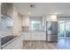 Bright kitchen featuring stainless steel appliances, white cabinetry, and a corner sink at 11133 W Cameo Dr, Sun City, AZ 85351