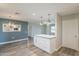 This is a kitchen with new appliances and lighting fixtures and a grey island at 11133 W Cameo Dr, Sun City, AZ 85351