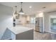 Charming kitchen with stainless steel appliances, a peninsula and sleek white cabinetry at 11133 W Cameo Dr, Sun City, AZ 85351