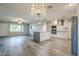 This is a kitchen with new appliances and lighting fixtures and a grey island at 11133 W Cameo Dr, Sun City, AZ 85351