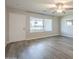 Bright, modern living room featuring sleek flooring and a large window providing ample natural light at 11133 W Cameo Dr, Sun City, AZ 85351