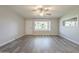 Bright, modern living room featuring sleek flooring and a large window providing ample natural light at 11133 W Cameo Dr, Sun City, AZ 85351