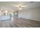 Spacious living area with hardwood flooring, with an open layout to the kitchen and dining area at 11133 W Cameo Dr, Sun City, AZ 85351