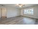 Bright, open living room with modern flooring, large window, and neutral wall color at 11133 W Cameo Dr, Sun City, AZ 85351