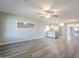 Spacious living area with hardwood flooring, with an open layout to the kitchen and dining area at 11133 W Cameo Dr, Sun City, AZ 85351