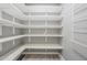 Spacious pantry with multiple shelves offering ample storage space at 11133 W Cameo Dr, Sun City, AZ 85351