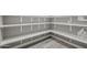 Organized pantry with gray walls, white shelves, and wood-look flooring for efficient storage solutions at 11133 W Cameo Dr, Sun City, AZ 85351