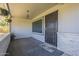 Cozy front porch features brick accents, decorative tile, and a secure metal security door at 11133 W Cameo Dr, Sun City, AZ 85351