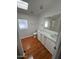 Bathroom with double sinks, white cabinets, and a window providing natural light at 11596 W Sierra Dawn Blvd # 372, Surprise, AZ 85378