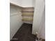 A walk-in closet has carpet and wood shelving for optimal storage at 11596 W Sierra Dawn Blvd # 372, Surprise, AZ 85378