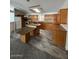 Spacious kitchen featuring an island, wood cabinets, and modern appliances at 11596 W Sierra Dawn Blvd # 372, Surprise, AZ 85378