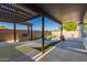 Covered patio space looks out to a pool, pergola, and outdoor grill at 11622 W Palm Brook Dr, Avondale, AZ 85392