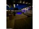 Outdoor area featuring a sparkling pool with underwater lights, covered patio, and lush landscaping at 11622 W Palm Brook Dr, Avondale, AZ 85392
