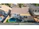 Aerial shot of backyard featuring a pool, covered patio, and well-maintained turf at 11622 W Palm Brook Dr, Avondale, AZ 85392